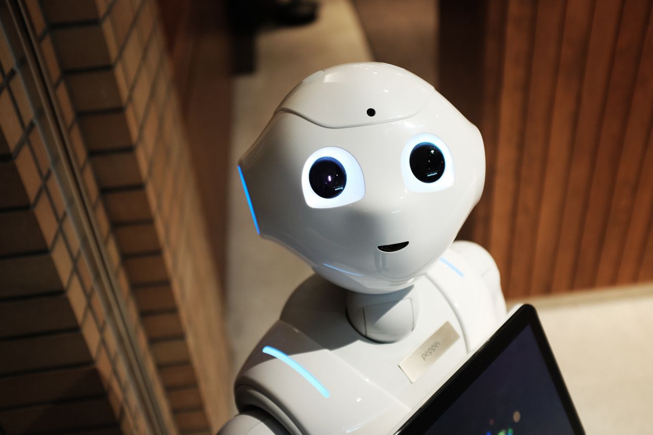 Menu A futuristic humanoid robot in an indoor Tokyo setting, showcasing modern technology.