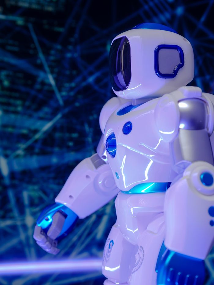 Menu Close-up of a modern humanoid robot with glowing blue lights and futuristic design.